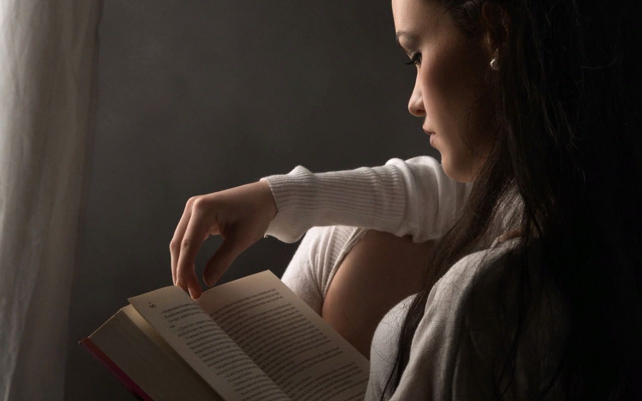 Девушка внимательно читает книгку