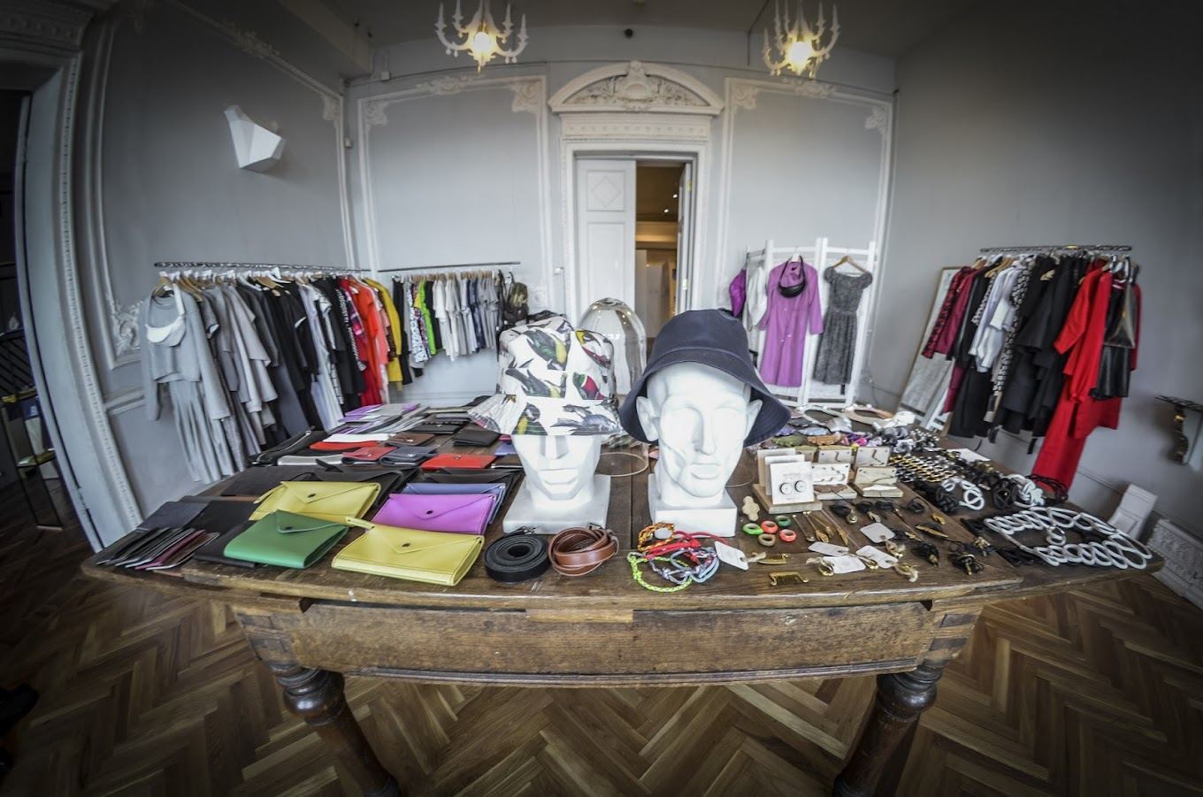 Стол с аксессуарами и стойки с одеждой в магазине 8 Store