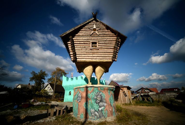 Настоящая избушка на курьих ножках, стоящая на деревянных сваях, стилизованных под куриные лапы